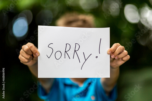 Boy with Sorry sign photo