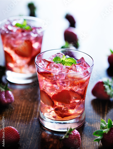 cocktail with strawberries, ice, and mint
