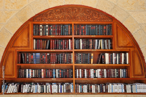 Jewish prayer books on the shelves. photo