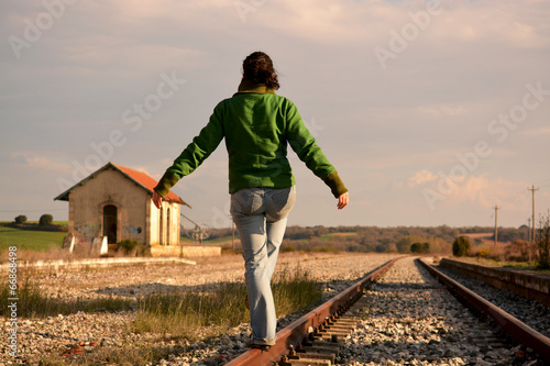 mujer bailando en las vias del tren photo