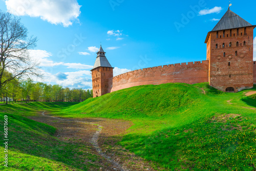 green lawn and a moat around the walls of the Novgorod Kremlin