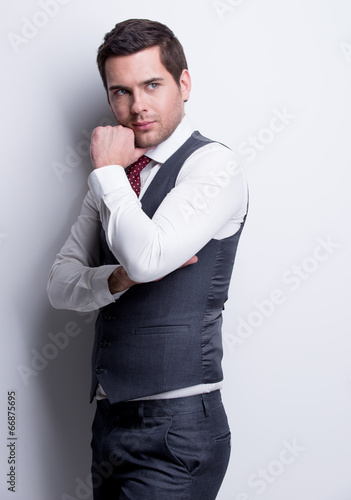 Portrait of young businessman in gray suit.