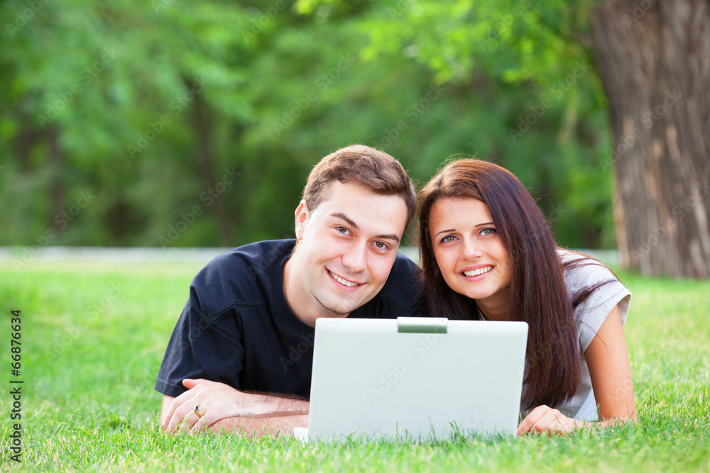 Teen couple with gift in the park. Teen couple with gift in the park.