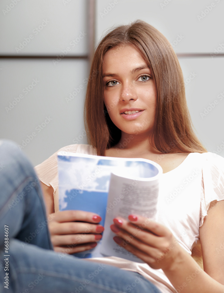 beautiful young woman on the couch with a book beautiful young woman on the couch with a book