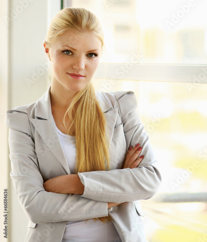 business woman in modern building , standing near windows