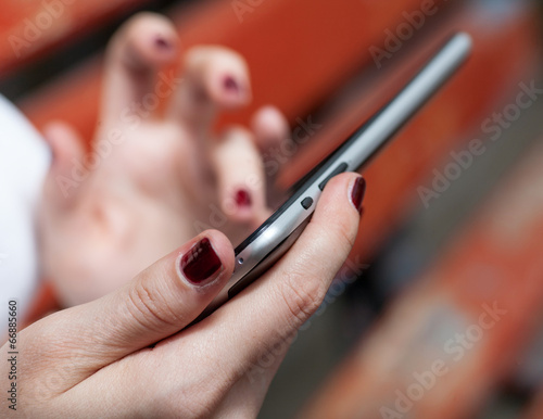 Very closeup of female hands with tablet pc