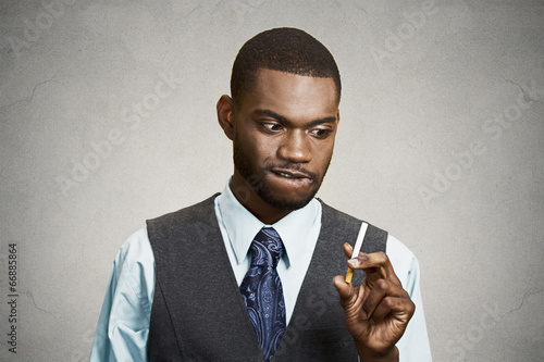 Portrait young business man craving a cigarette, to smoke photo