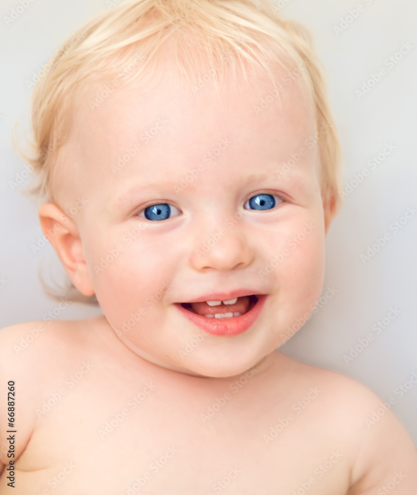 Smiling blond baby with blue eyes Smiling blond baby with blue eyes