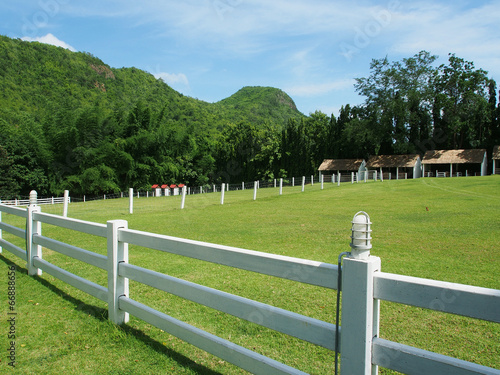 County style white fence in farm field