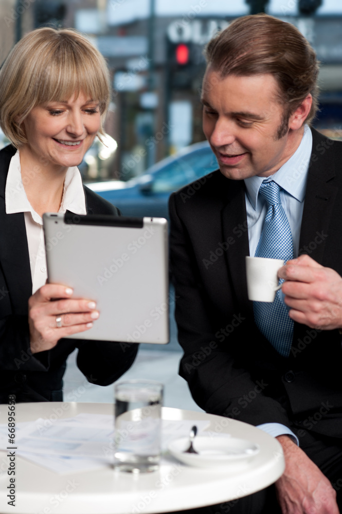 Cheerful business people using digital tablet Cheerful business people using digital tablet