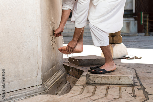 Muslim Washing Feet Before Entering Mosque photo