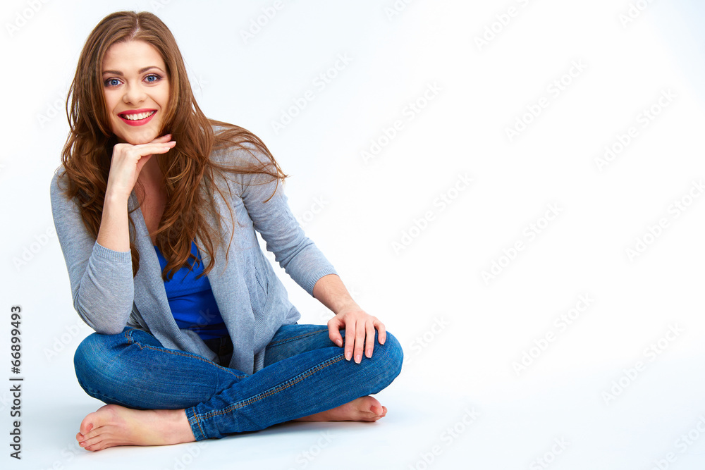 Young woman sitting on a floor. Isolated on white background Young woman sitting on a floor. Isolated on white background