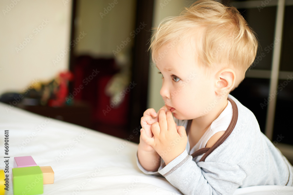 Cute little boy playing with blocks.