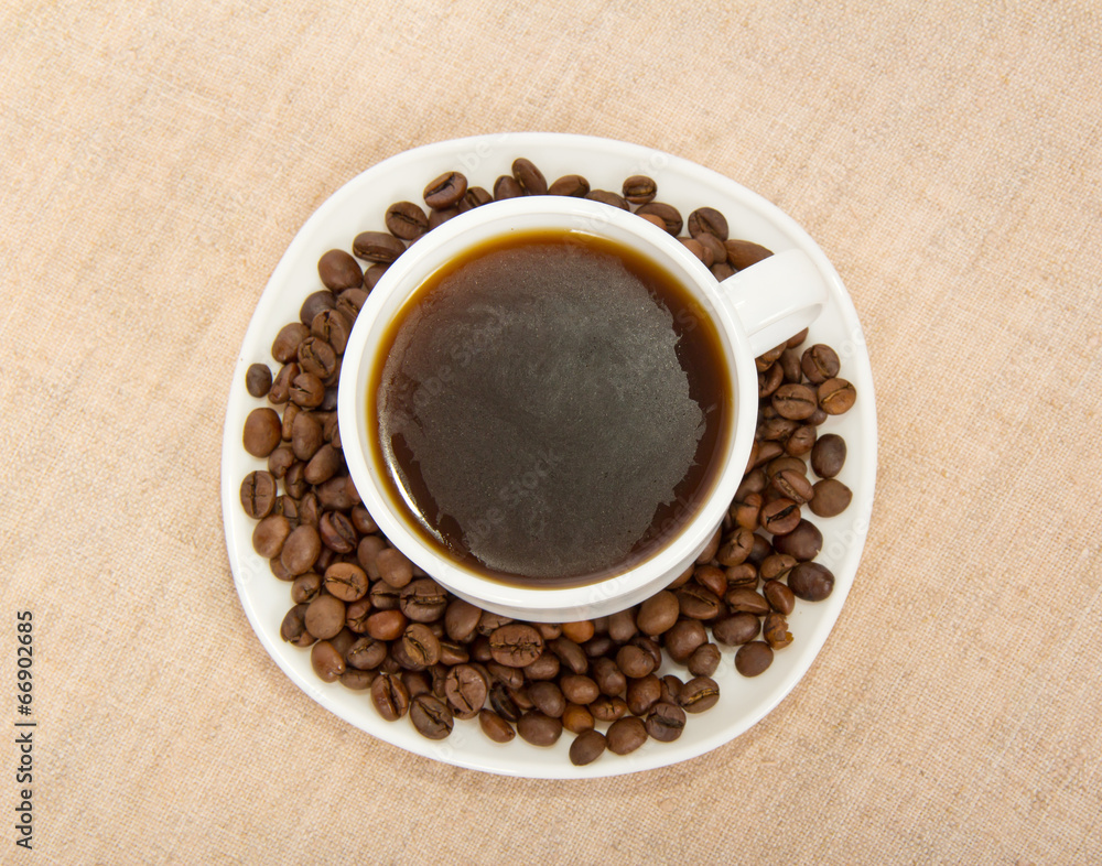 Fototapeta premium White cup of coffee with grains