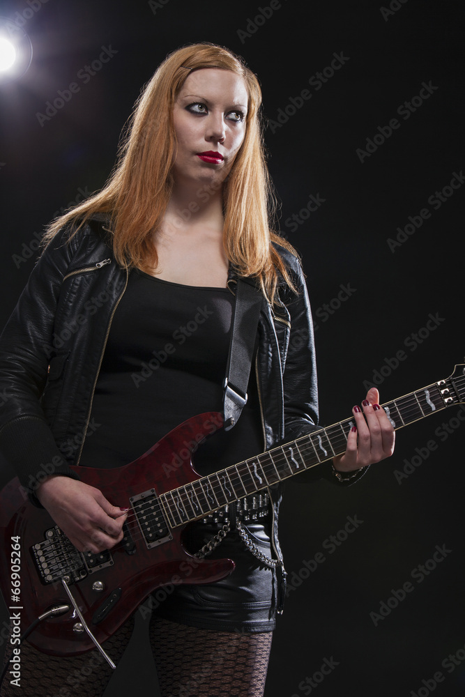 Obraz premium Young Woman Playing Guitar