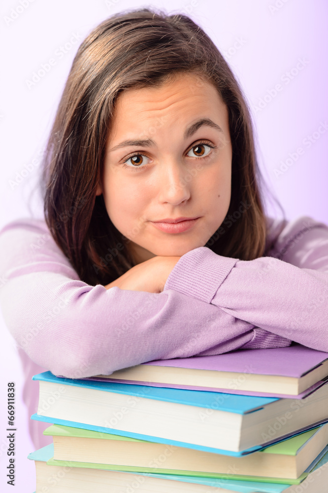 Desperate student girl leaning on stack books Desperate student girl leaning on stack books
