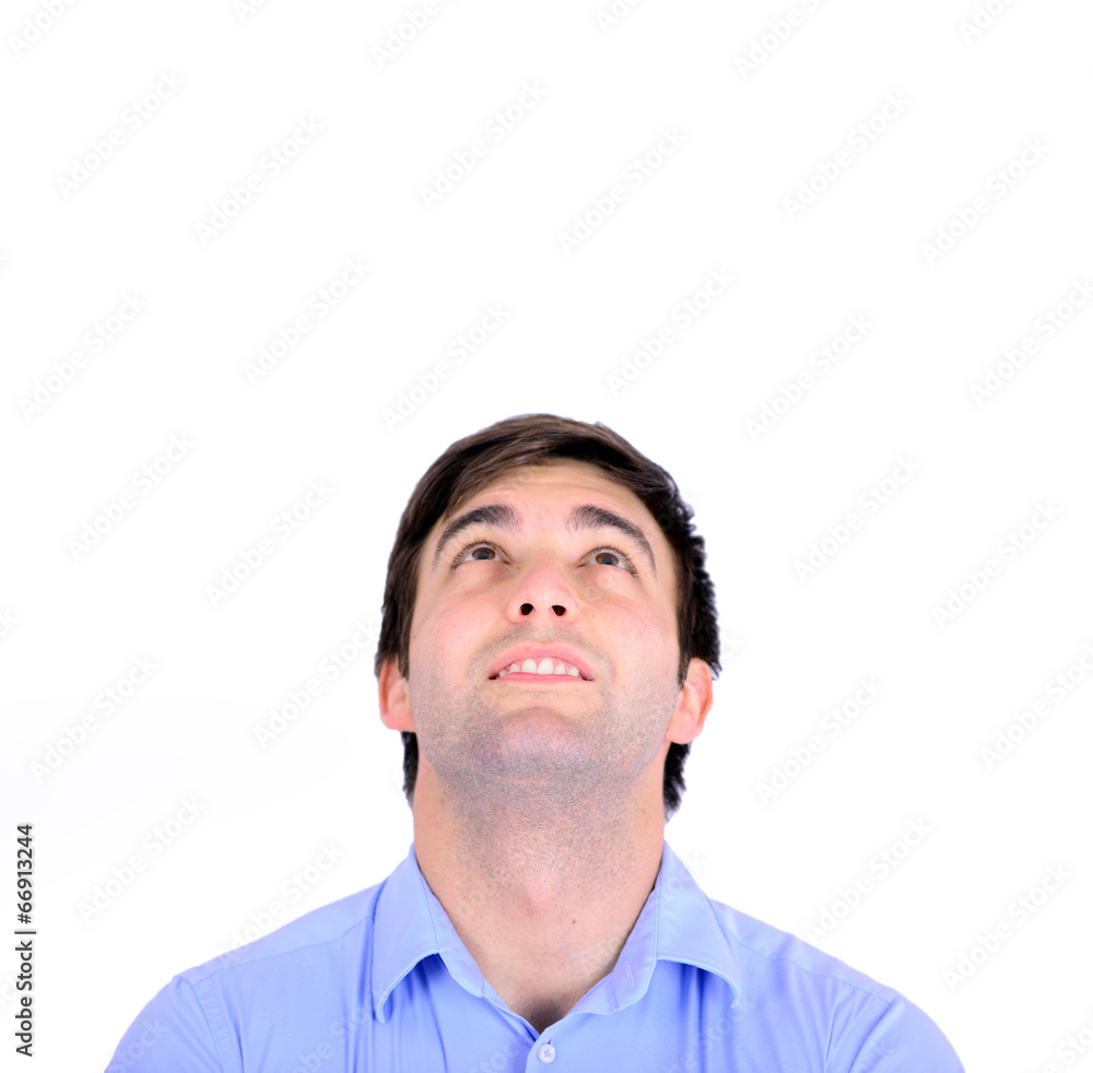 Portrait of smiling handsome young man looking above isolated o Portrait of smiling handsome young man looking above isolated o