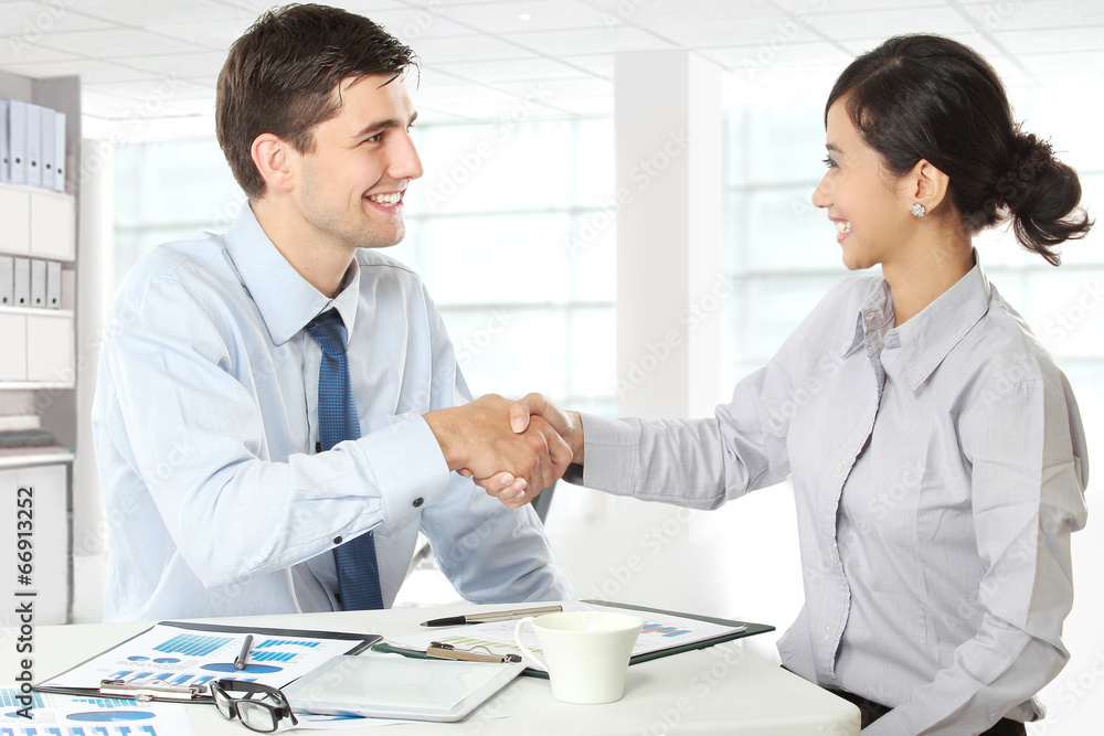 Interviewer shaking hand to future employee Interviewer shaking hand to future employee