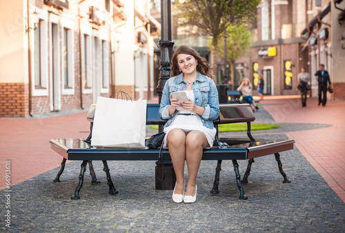 woman with tablet relaxing on bench after shopping © Кирилл Рыжов