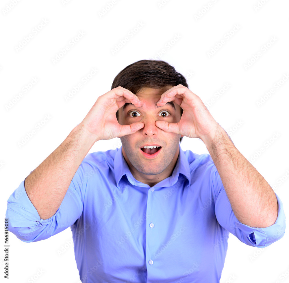 Portrait of young surprised man looking through his fingers like Portrait of young surprised man looking through his fingers like