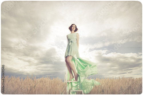 Beautiful woman in green dress background photo