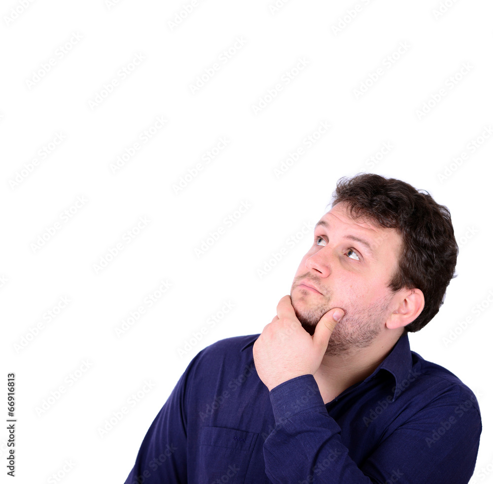 Portrait of chubby young man looking above and thinking about so Portrait of chubby young man looking above and thinking about so