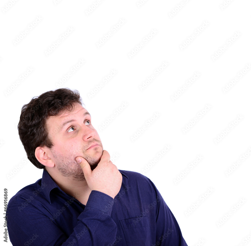 Portrait of chubby young man looking above and thinking about so Portrait of chubby young man looking above and thinking about so