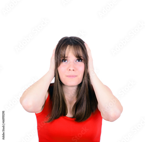 Frustrated woman covering her ears and looking up isolated on wh