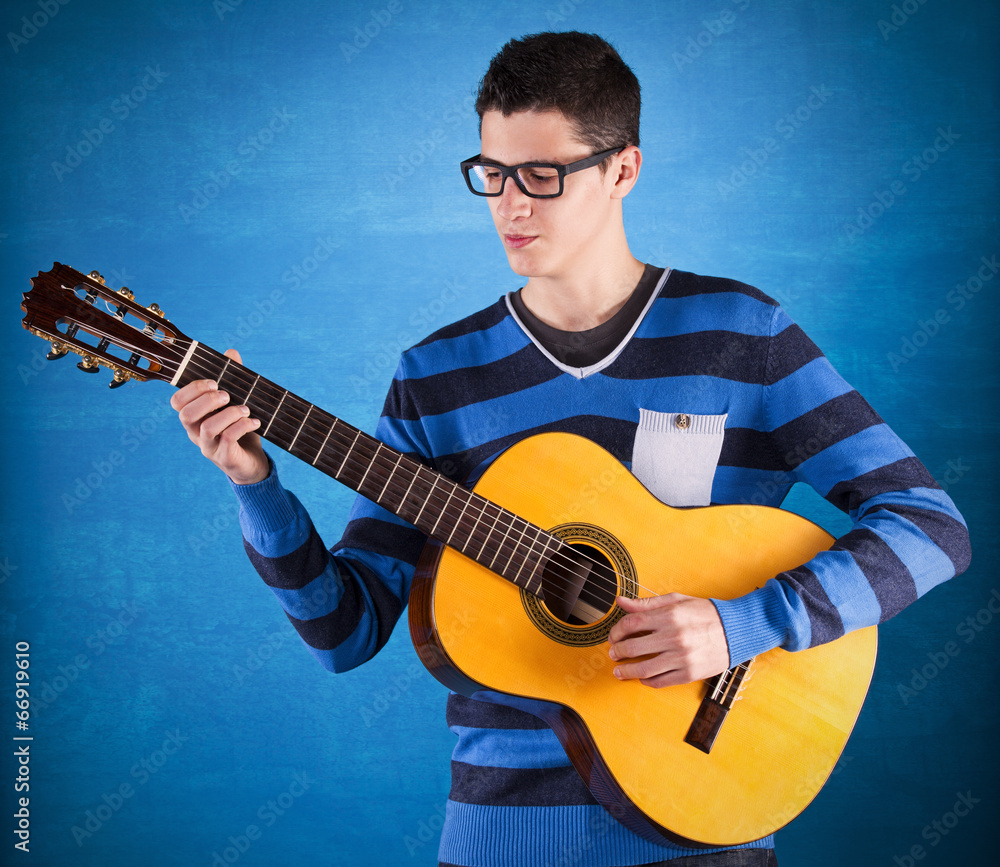 Teenager holding a classic guitar