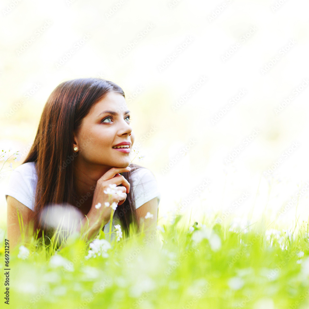 Pretty brunette girl laying on grass Pretty brunette girl laying on grass