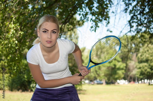Young woman playing tennis © dukibu