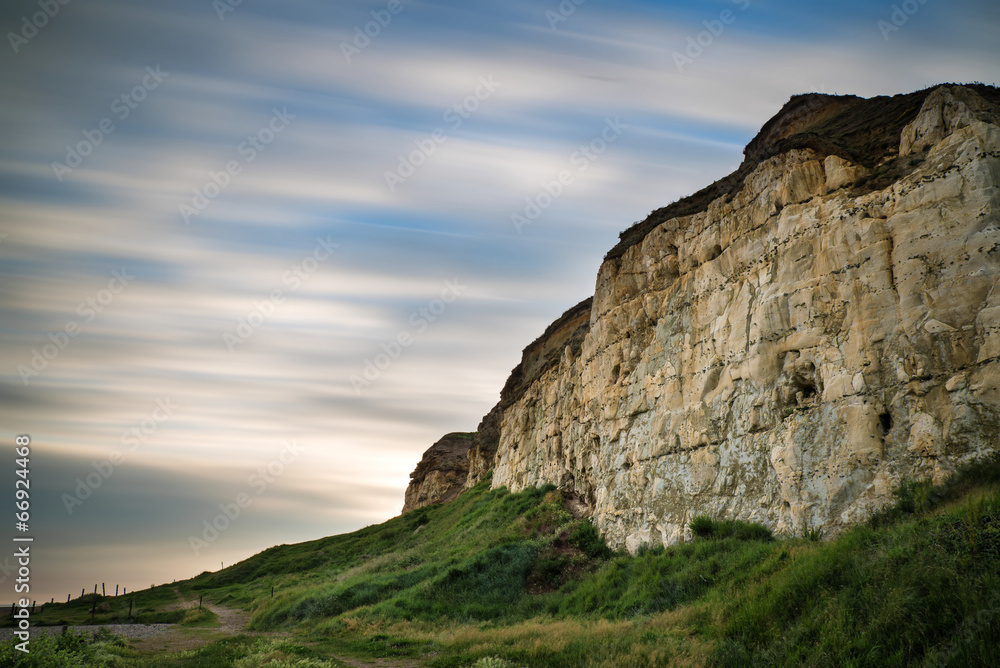 Long exposure landscape of motion blur sky over vibrant cliffs