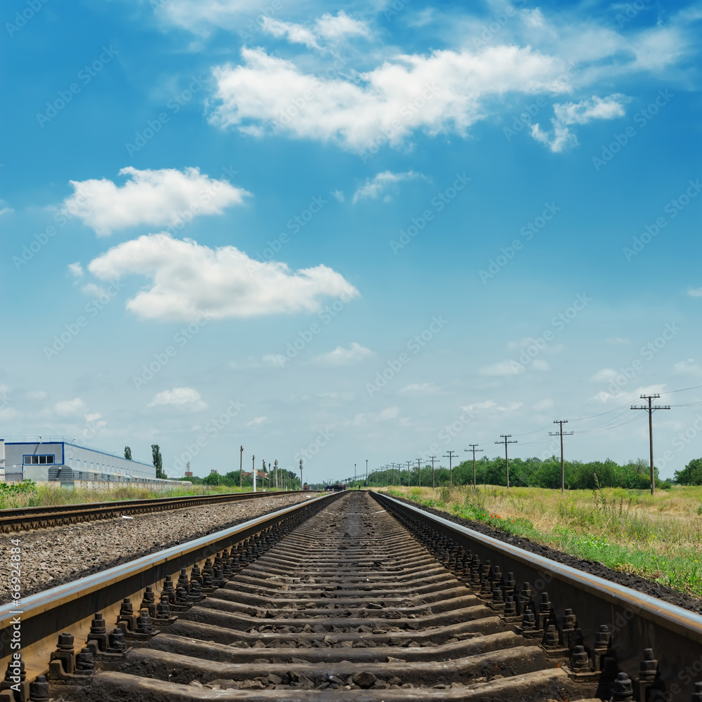 railroad closeup and clouds in blue sky