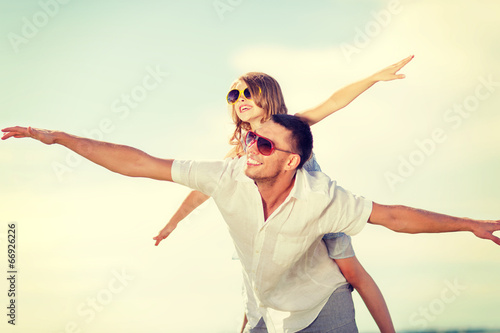 happy father and child in sunglasses over blue sky