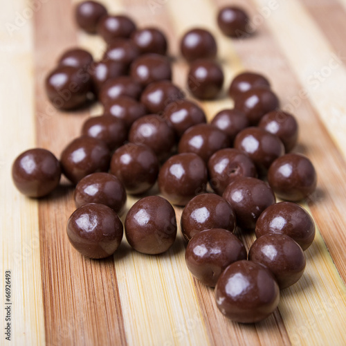 Round chocolate candies on the wooden table