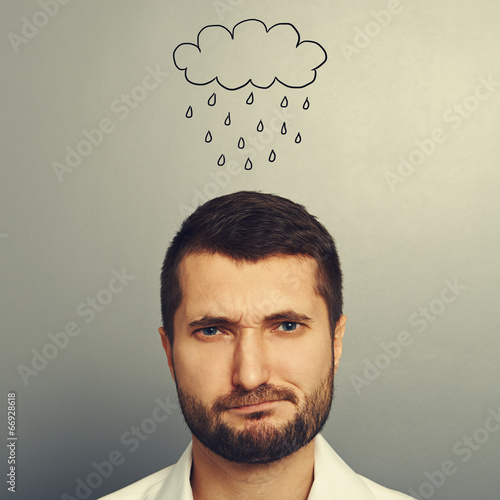 dissatisfied man with drawing storm cloud