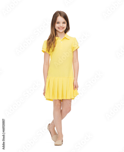 smiling little girl in yellow dress © Syda Productions