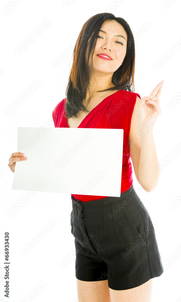 Saleswoman holding a blank placard with her fingers crossed Saleswoman holding a blank placard with her fingers crossed
