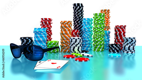 Poker Chips, sunglasses and cards on a gaming table.