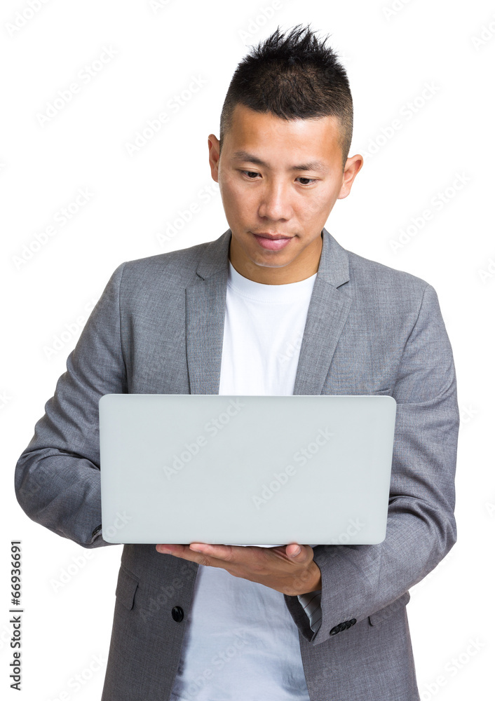 Businessman look at notebook computer Businessman look at notebook computer