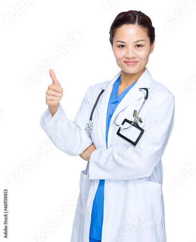 Female medical doctor with thumb up