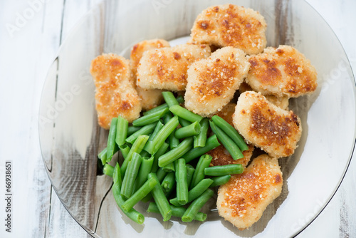 Sesame chicken nuggets with beans, view from above, studio shot