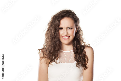 beautiful confused girl on white background © vladimirfloyd