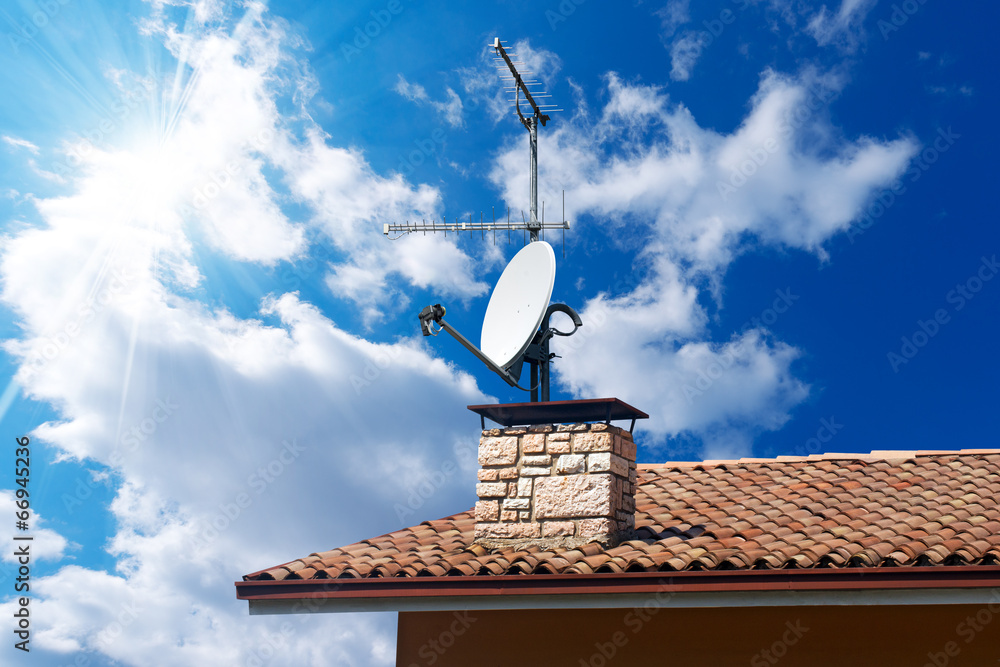 Foto Stock Satellite Dish and Antenna TV on Blue Sky | Adobe Stock