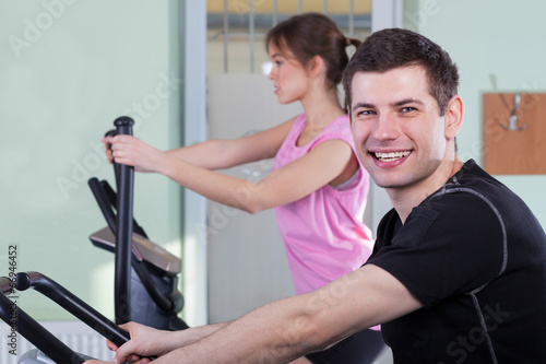 Couple exercising at fitness gym