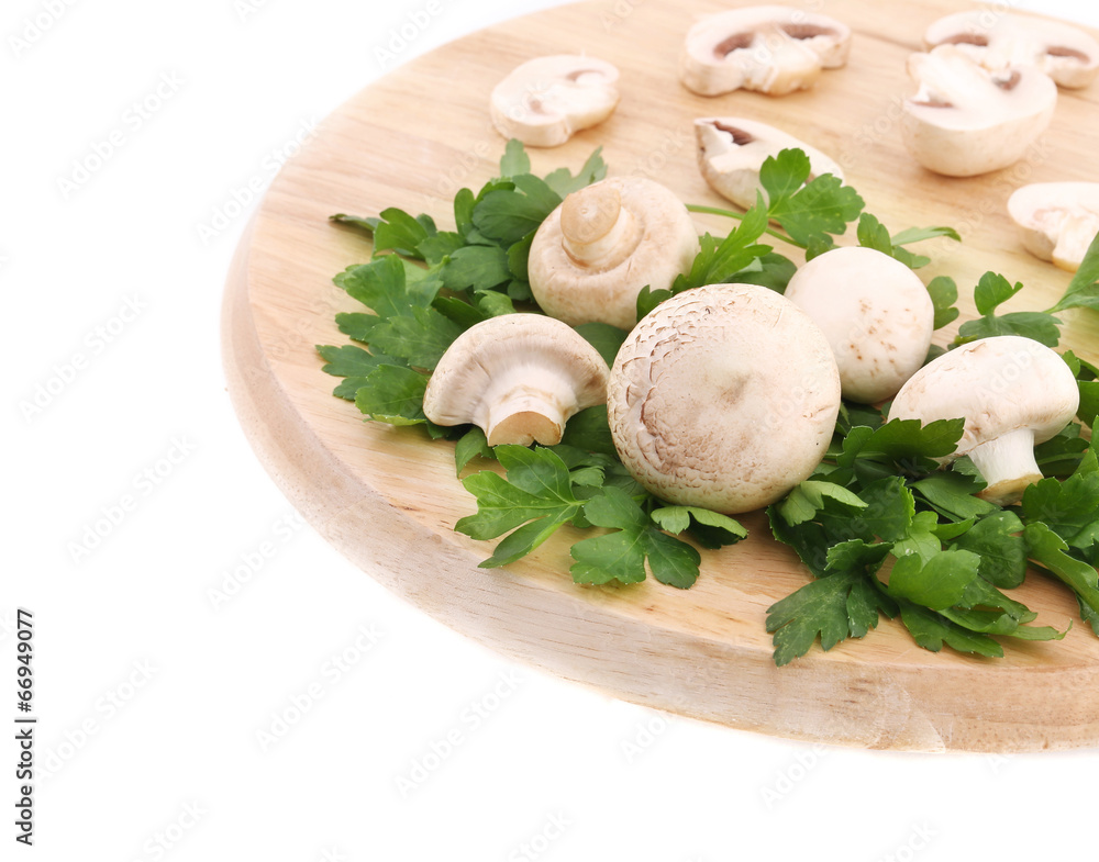 Champignons and parsley on wooden platter. Champignons and parsley on wooden platter.