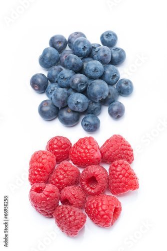 fresh raspberries and blueberries, top view, isolated