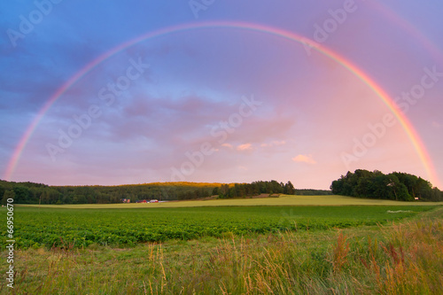 Rainbow over Swedish farm field