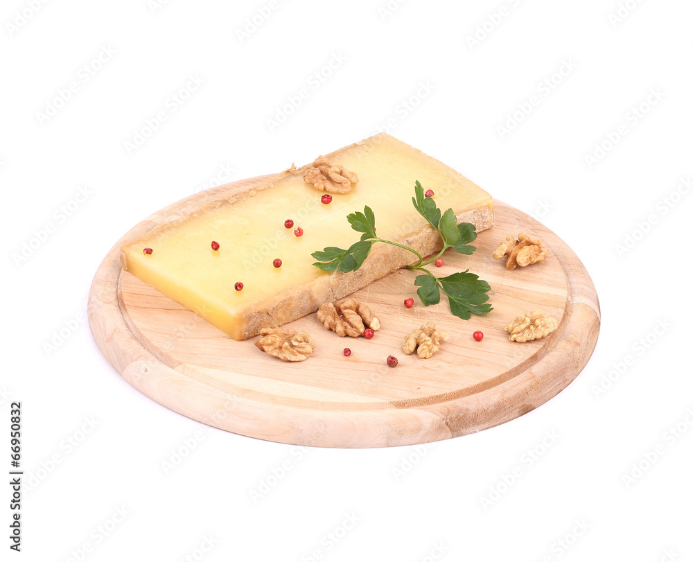 Cheese on wooden platter with walnuts. Cheese on wooden platter with walnuts.