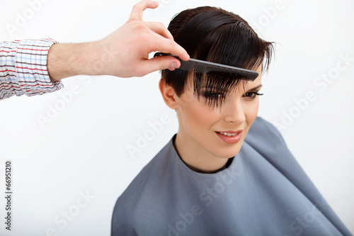 Hairdresser doing Hairstyle. Brunette with Short Hair 